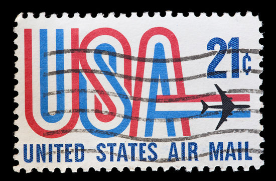 United States used postage stamp showing aircraft over USA word