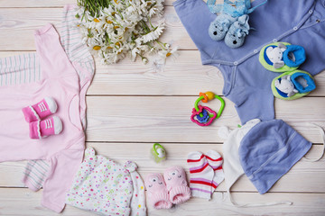 newborn baby clothes on wooden background
