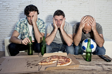 friends fanatic football fans watching tv match with beer bottles and pizza suffering stress