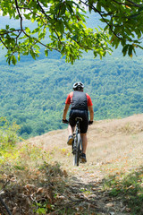Mountain biker riding cross country
