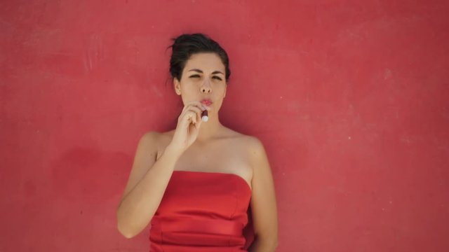 Young hispanic people smoking e-cig, pretty sensual latina woman with electronic cigarette, happy sexy girl smiling and blowing smoke. Slow motion portrait
