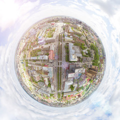 Aerial city view with crossroads and roads, houses, buildings, parks and parking lots, bridges. Copter shot. Panoramic image.