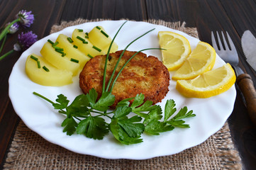 Fishcake, potato salad and lemon slices