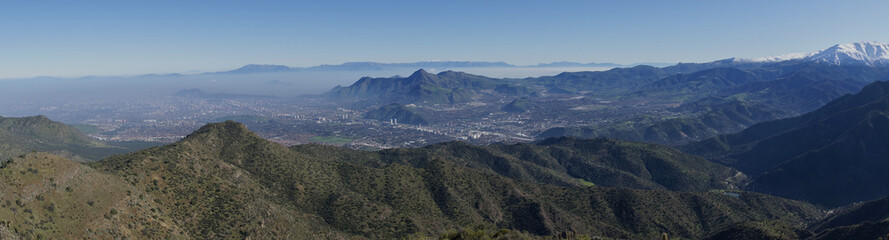 Panoramic view of Santiago, capital of Chile. Viewed from Parque Puente Nilhue in the foothills of the Andes Mountains looking towards Cerro Manquehue (1,635m).