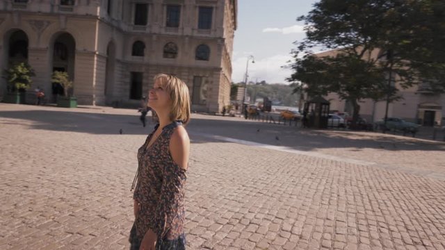Female friends on holidays, people traveling, young women having fun on vacation, two happy girls smiling in Havana, Cuba, taking pictures with camera near Cuban monument. Steadicam, steadycam shot
