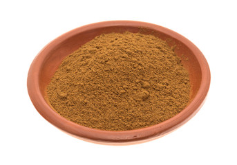 Bowl of cinnamon spice on a white background side view