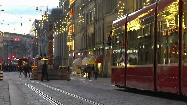 Festive atmosphere in decorated old city downtown, people go shopping for gifts