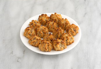Chocolate chip macaroons in a dish on marble table