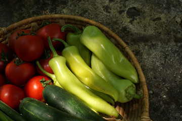 Vegetables in a basket on a stone base