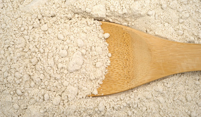 Close view of caramel cake mix with wood spoon