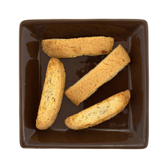 Almond nut biscotti on a brown plate top view