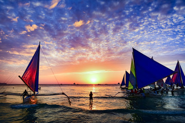 BORACAY, PHILIPPINES - JANUARY 12, 2015 - Several tourists are enjoying the spectacular sunset on...