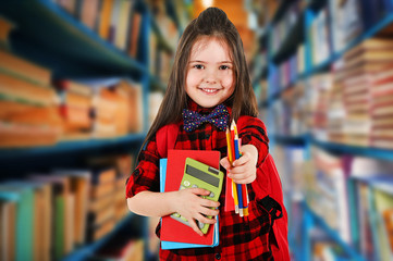 Girl with books in school library