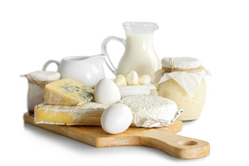 Set of fresh dairy products on wooden board, isolated on white