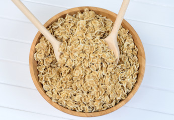 Organic oat flakes in bamboo bowl