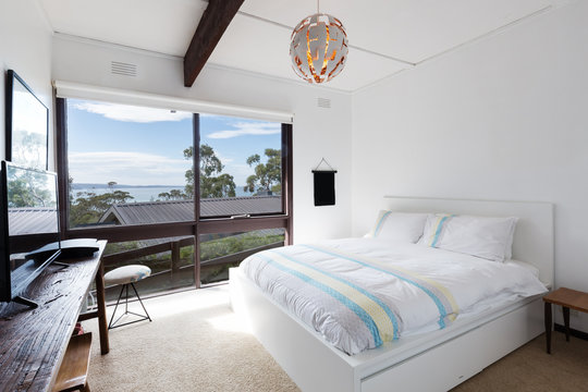 View Of The Ocean From A Retro Beach House Bedroom