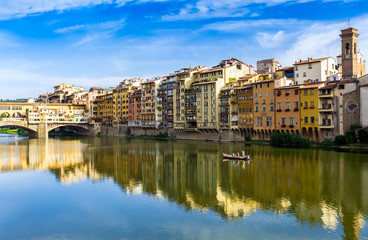 view of the famous Ponte Vecchio, the Arno River at sunset in Fl