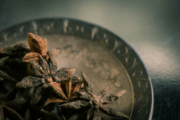 Spices. Anise stars photo. Intentionally blurred lens focus effect. Color toning.