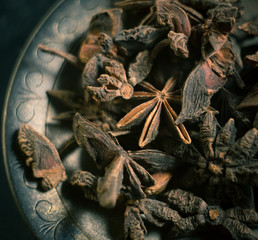 Spices. Anise stars photo. Intentionally blurred lens focus effect. Color toning.