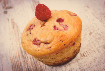 Vintage photo, Fresh baked cupcake with raspberries, delicious dessert