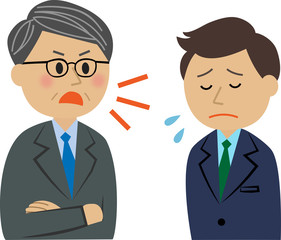 叱られるスーツ姿の男性