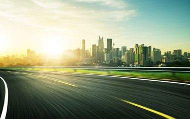freeway at sunset, motion blur with city background .