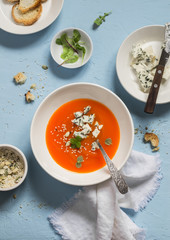 Pumpkin soup with blue cheese on a blue stone background. Healthy food