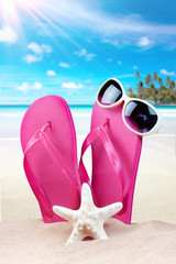 Summer background with starfish and accessories on sand beach