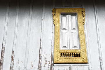 laos style pattern window on the wall at temple