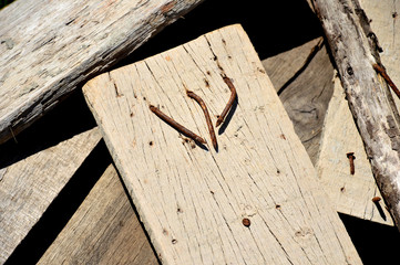 Old nails on old wood put on stack of woods.