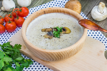 Top View on a Creamy Champignon Soup in Wooden Bowl with Sautée
