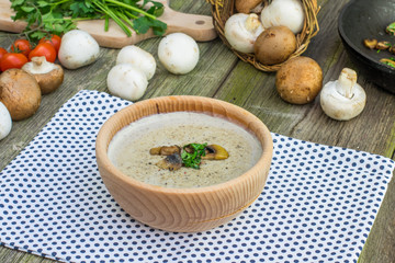 Creamy Champignon Soup in Wooden Bowl with Sautéed Champignon M