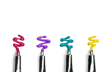 Colorful water color tubes on white background