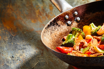 Close up of vegetable dish in oil stained pan