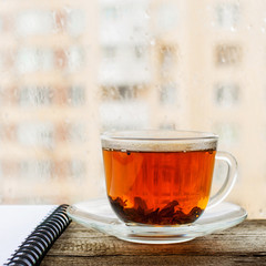 Black tea in cup of glass on the windowsill