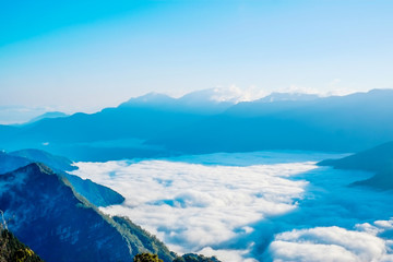 Beautiful morning sunrise, dramatic cloud of sea, giant rocks and Yushan mounatin under bright blue sky in Alishan(Ali mountain) National Park, Taiwan