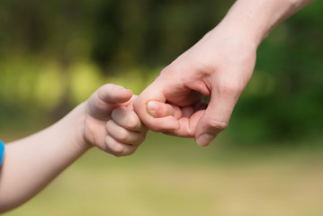 Man and young boy play with hands