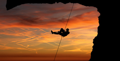 Silhouette of a climber over beautiful sunset