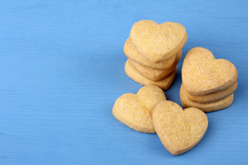 tasty cookies in the shape of a heart on a brown wooden table