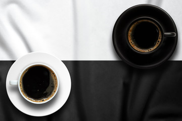 Top view of coffee cup put on a tablecloth., Tablecloth is stripe pattern punctuate black and white...