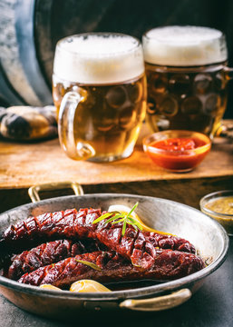 Sausage. Roasted chorizo sausage. Roasted spicy sausage chorizo home hotel or restaurant with beer vine brandy cognac whiskey. Still life. Toned photo.