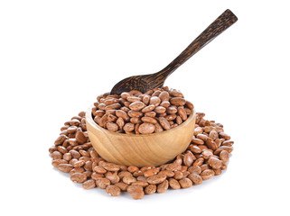 uncooked pinto beans in wooden bowl on white background