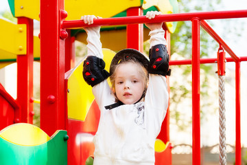 The girl climbs the jungle gym at the Playgroun