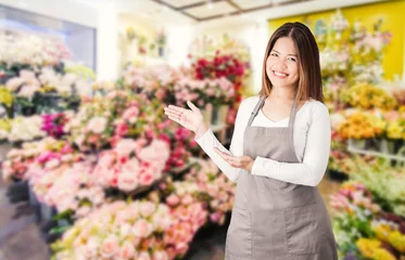 Wall murals Flower shop asian female florist with flower shop background