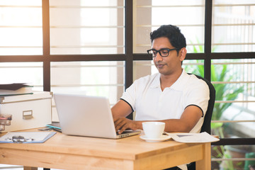 Fototapeta na wymiar casual indian male working at office