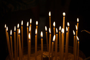 burning candle decoration against black background