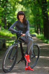 cyclist woman riding a bicycle in park