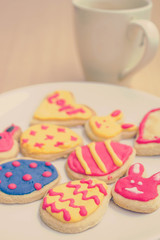 colorful easter cookies on white plate