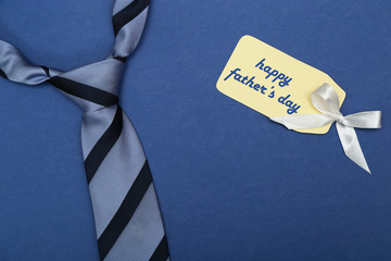Happy fathers day sign on paper and blue tie