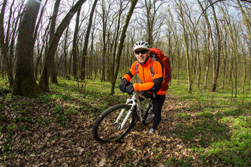 Naklejka premium Cyclist Riding the Bike in Beautiful Spring Forest